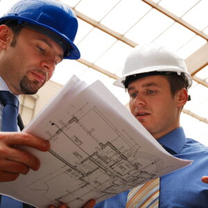 Two construction workers in hardhats looking at blueprints, New Construction Window Installation